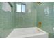Bathroom features white tub with green subway tile backsplash at 524 Hopi Pl, Boulder City, NV 89005