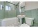 Bathroom featuring green subway tiles, pedestal sink and decorative tile floors at 524 Hopi Pl, Boulder City, NV 89005