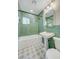 Bathroom features green tile, pedestal sink and combo tub and shower at 524 Hopi Pl, Boulder City, NV 89005