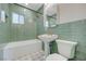 Bathroom features green tile, pedestal sink and combo tub and shower at 524 Hopi Pl, Boulder City, NV 89005