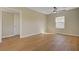 Bright bedroom featuring hardwood floors, ceiling fan and natural light at 524 Hopi Pl, Boulder City, NV 89005