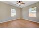 Bedroom with wood-look floors, ceiling fan and two windows, providing natural light at 524 Hopi Pl, Boulder City, NV 89005
