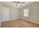 Bright bedroom features wood-look tile flooring, ceiling fan, and natural light from a window at 524 Hopi Pl, Boulder City, NV 89005