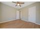 Bedroom featuring wood-look tile flooring, ceiling fan and neutral color scheme at 524 Hopi Pl, Boulder City, NV 89005