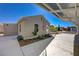 View of the side of the house, showing the yard, landscape, and the covered parking area at 524 Hopi Pl, Boulder City, NV 89005