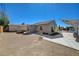 View of the home's exterior with a gravel backyard, patio, and detached structure at 524 Hopi Pl, Boulder City, NV 89005