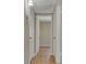 Hallway featuring hardwood floors with multiple access doors at 524 Hopi Pl, Boulder City, NV 89005