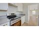 Kitchen showcasing stainless steel oven, stone counters and light cabinets at 524 Hopi Pl, Boulder City, NV 89005