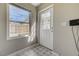 Laundry room showing the tile floor, white door, and a window at 524 Hopi Pl, Boulder City, NV 89005