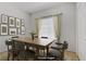 Dining room featuring a wood table with seating, neutral decor, and a window at 525 Indian Princess Dr # 101, Las Vegas, NV 89145