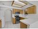 Functional kitchen with stainless steel appliances, tiled countertops, and a serving hatch at 525 Indian Princess Dr # 101, Las Vegas, NV 89145