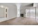 Open-concept living area with tile flooring, fireplace, patio access, and views to the kitchen at 525 Indian Princess Dr # 101, Las Vegas, NV 89145