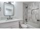 Bright bathroom offers a shower-tub, modern vanity with black fixtures, and updated tile at 5279 Consul Ave, Las Vegas, NV 89142