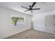 Bedroom with neutral carpet, white walls and trim, and an exterior view at 5279 Consul Ave, Las Vegas, NV 89142