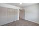 Bedroom featuring gray carpet, white walls, closet and an open doorway at 5279 Consul Ave, Las Vegas, NV 89142