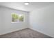 Clean, carpeted bedroom features a large window and fresh white paint at 5279 Consul Ave, Las Vegas, NV 89142