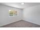 Bright bedroom with gray carpet, white walls, and a window view at 5279 Consul Ave, Las Vegas, NV 89142