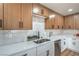 Modern kitchen with light wood cabinets, stainless steel appliances, and white backsplash at 5279 Consul Ave, Las Vegas, NV 89142