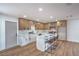 Bright kitchen features wood and white cabinets, stainless steel appliances and an island with seating at 5279 Consul Ave, Las Vegas, NV 89142
