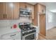 The bright and airy kitchen features stainless steel appliances, wood cabinets, white countertops, and modern fixtures at 5279 Consul Ave, Las Vegas, NV 89142