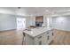 Open-concept kitchen and living room featuring an island with seating, updated cabinets, new appliances, and a fireplace at 5279 Consul Ave, Las Vegas, NV 89142