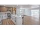 The spacious kitchen with seating area, stainless steel appliances, and wood cabinets looks out to the living room at 5279 Consul Ave, Las Vegas, NV 89142