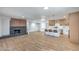 Open concept living room with modern fireplace flows into a kitchen with bar seating at 5279 Consul Ave, Las Vegas, NV 89142