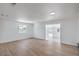 Open living room features wood-look floors and bright white walls with ample sunlight at 5279 Consul Ave, Las Vegas, NV 89142