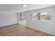 Bright living room with wood-style flooring, recessed lighting, and a sliding glass door to the outside at 5279 Consul Ave, Las Vegas, NV 89142