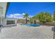 Backyard pool with white gravel landscaping, concrete patio, and mature palm trees create a private oasis at 5279 Consul Ave, Las Vegas, NV 89142