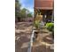 Backyard with open patio and dining, rock features and grassy area at 530 Calahonda Ct, Las Vegas, NV 89138