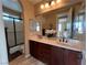 Bathroom features a double sink vanity with granite countertops and a framed shower at 530 Calahonda Ct, Las Vegas, NV 89138