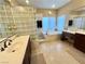 Bathroom features a garden tub, glass block window and large vanity at 530 Calahonda Ct, Las Vegas, NV 89138