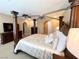 Bedroom with four post bed frame, a ceiling fan, and dark wood dresser at 530 Calahonda Ct, Las Vegas, NV 89138