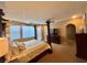 Bedroom with canopy bed frame, a ceiling fan and natural light from the windows at 530 Calahonda Ct, Las Vegas, NV 89138