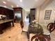 Dining room with dark wood table, a glass top, and tile flooring near kitchen and staircase at 530 Calahonda Ct, Las Vegas, NV 89138