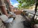 Cozy front porch with comfortable seating, potted plants, and a view of the neighborhood at 530 Calahonda Ct, Las Vegas, NV 89138