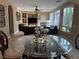 Bright living room with large windows, fireplace, and dark leather sofas for a cozy and inviting space at 530 Calahonda Ct, Las Vegas, NV 89138
