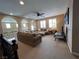 Bright loft area with a large sectional couch, neutral tones, and plenty of natural light at 530 Calahonda Ct, Las Vegas, NV 89138