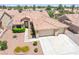 Aerial view showcases the home's tile roof, landscaping, and three-car garage at 5704 Owl Butte Ct, Las Vegas, NV 89149