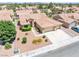 An aerial view of the home featuring a tile roof, well-kept landscaping, and a two-car garage at 5704 Owl Butte Ct, Las Vegas, NV 89149