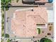 An aerial view displays the home's desert landscaping, tile roof, and backyard lounge area at 5704 Owl Butte Ct, Las Vegas, NV 89149