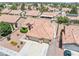 An aerial view of the home featuring a tile roof, well-kept landscaping, and a two-car garage at 5704 Owl Butte Ct, Las Vegas, NV 89149