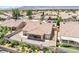 Aerial view of the charming single-story home, showcasing the neatly maintained landscaping and the serene backyard patio at 5704 Owl Butte Ct, Las Vegas, NV 89149