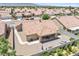 An aerial perspective of the home featuring its tile roof, covered patio, and xeriscaped backyard at 5704 Owl Butte Ct, Las Vegas, NV 89149