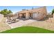 Inviting backyard with covered patio, beautiful landscaping, and room to relax at 5704 Owl Butte Ct, Las Vegas, NV 89149