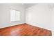 An empty bedroom with hardwood floors and large window at 5704 Owl Butte Ct, Las Vegas, NV 89149