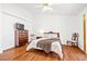 Comfortable bedroom with hardwood floors, ceiling fan, and warm decor for a relaxing ambiance at 5704 Owl Butte Ct, Las Vegas, NV 89149