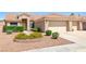Well-maintained front exterior with a two-car garage, tidy landscaping, and a welcoming entrance at 5704 Owl Butte Ct, Las Vegas, NV 89149