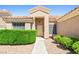 Charming front entrance with a well-maintained walkway and manicured shrubbery, enhancing curb appeal at 5704 Owl Butte Ct, Las Vegas, NV 89149